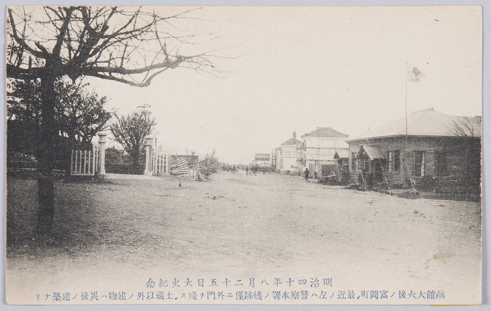 作品画像:明治四十年八月二十五日大火紀念 函館大火後ノ富岡町 最近ノ左ハ警察本署ノ焼跡僅ニ外門ヲ残ス 土蔵以外ノ建物ハ災後ノ建築ナリ